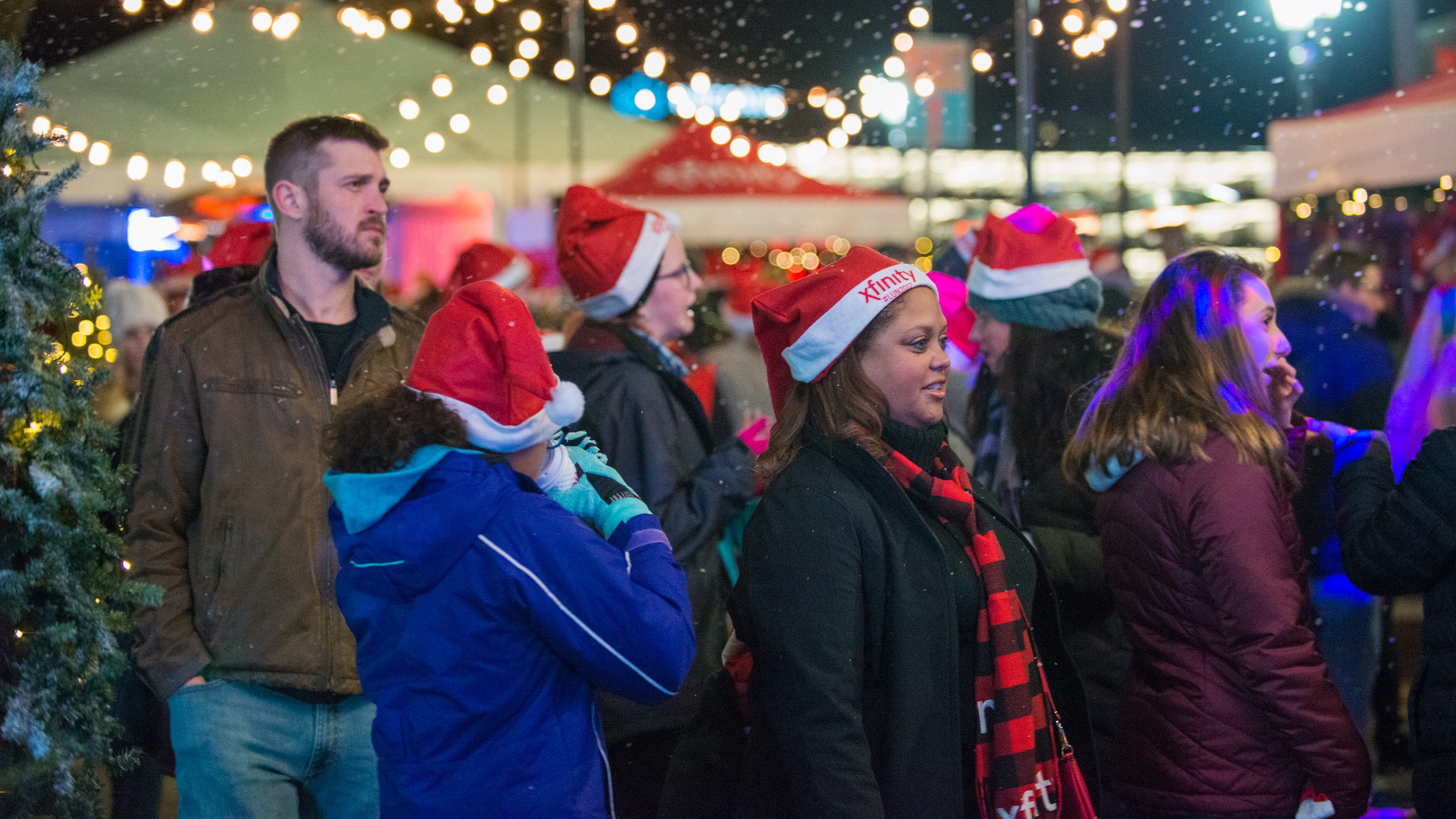 A crowd of people standing in a Christmas festival.